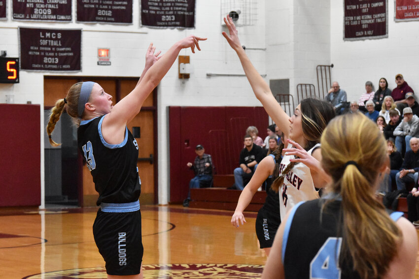 Sullivan West’s Sophie Flynn launches a long range jumper. Flynn had six points as the Bulldogs defeated the Bears.