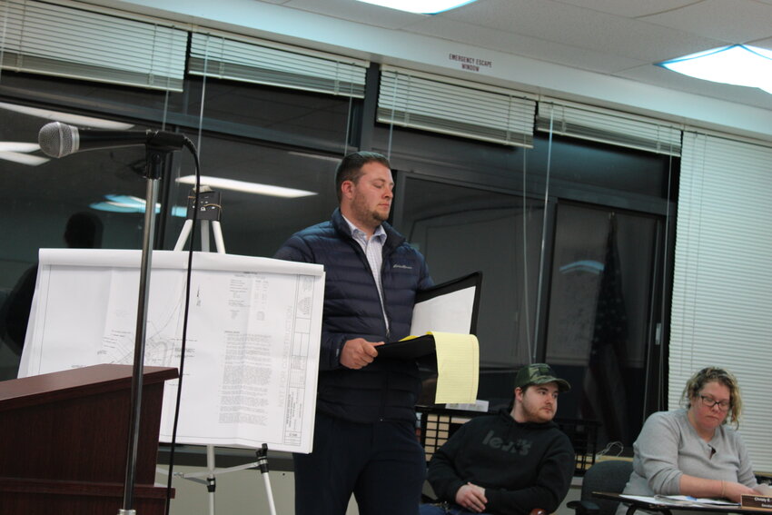 Designer Hayden Carnell exhibiting plans for King&rsquo;s Collision Services on Royce Road at the Bethel Town Board meeting.