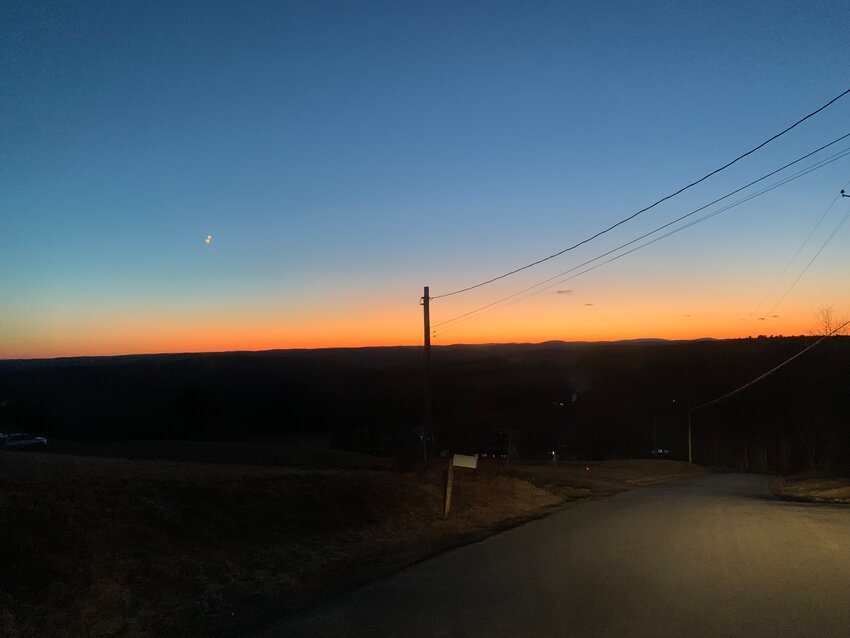 This cellphone photo of the round orbs, upper left of photo, was taken by Julio Valetin at 6:20 Thursday evening. He is on Beechwoods Rd., looking west, with Radio Tower Rd. on his right.