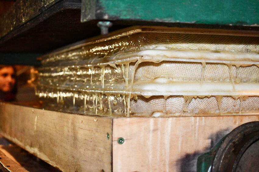 Slats are used to press down on the apples creating the cider.