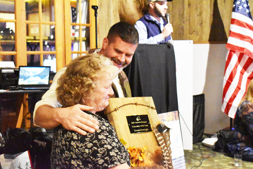 Donna Kortright receives her Volunteer of the Year Award from Regional Director Carter Heath.