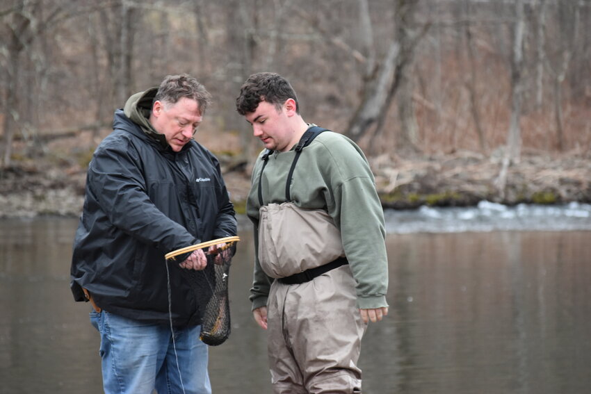 Robert Shaw Jr and Robert Shaw III check out their first trout of the season.
