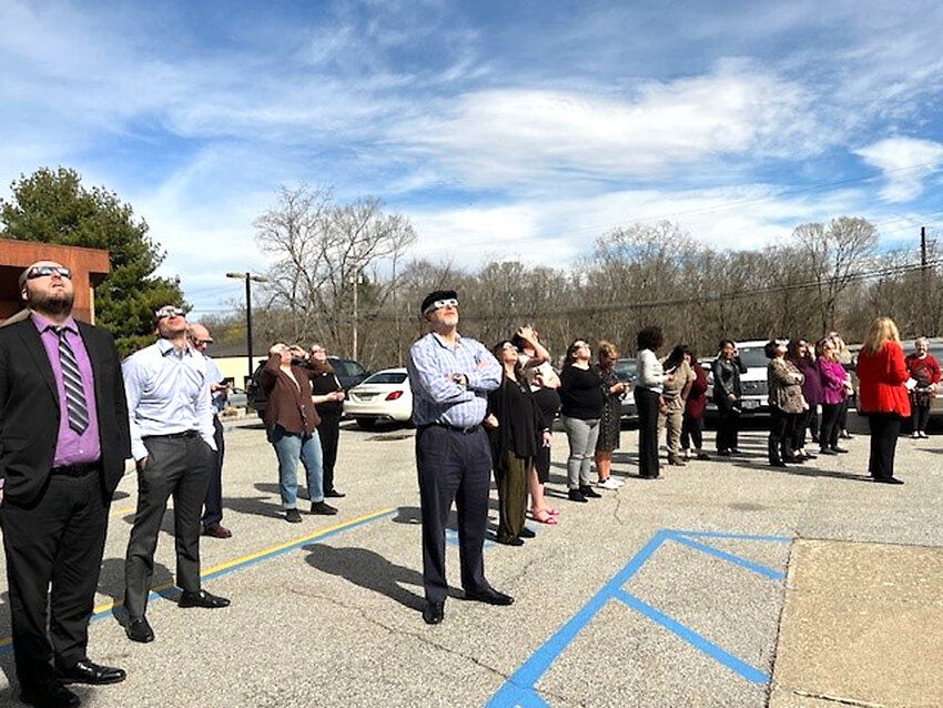 J&amp;G employees viewing the solar eclipse with their glasses.