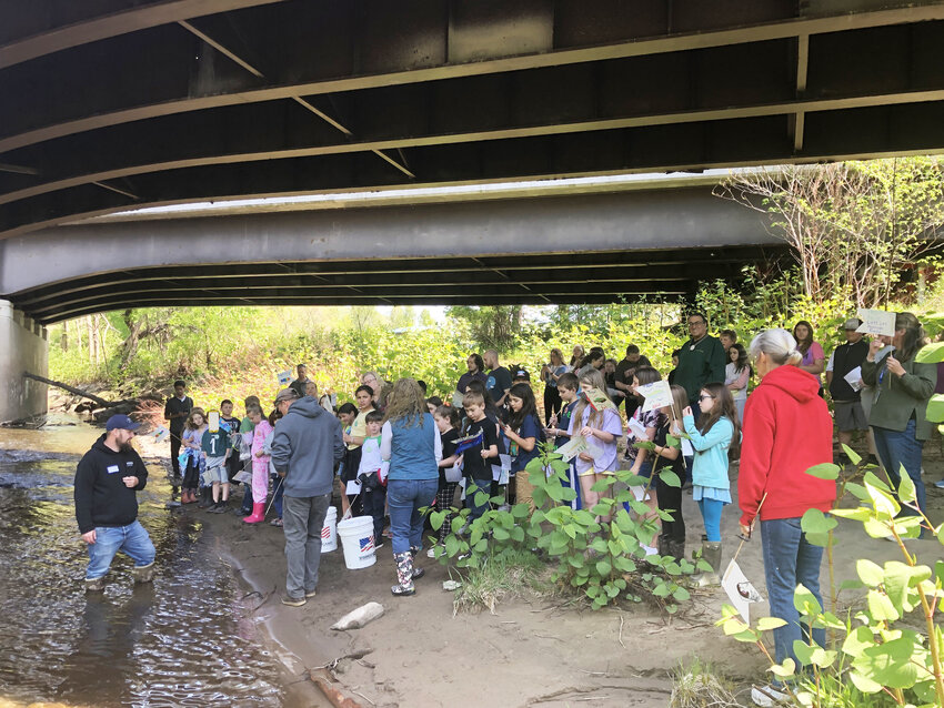 After raising the young trout all year, the students released them into the river on Monday morning.