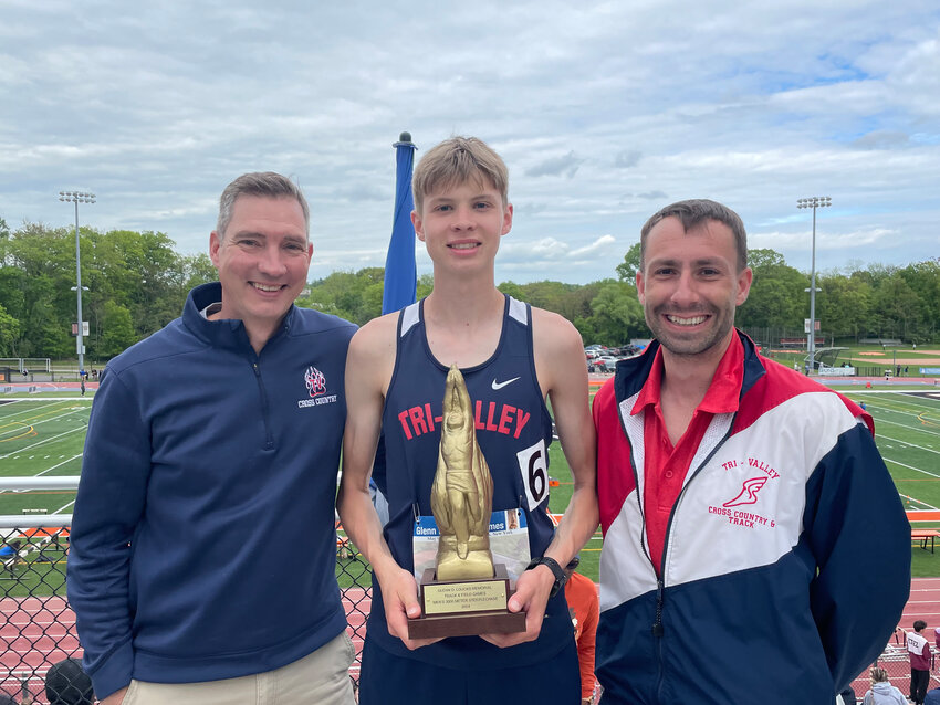 Chip Furman (left) and Travis Wolfe (right) stand alongside Van Furman, who broke the school record for the 3000m Steeplechase last weekend at the Loucks Games.