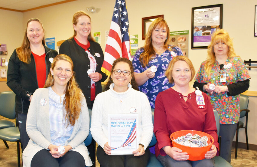 Staff of the Honesdale VA Outpatient Clinic with Moment of Remembrance Campaign Buttons are: seated, left to right, Jessica Woodmansee, FNP-BC, Dr. Susan Mowatt, Jolene Pryzant, LPN case manager. Standing: Tracy Robinson, medical support assistant, Nicole Woodmansee, Rheanon Weston, LPN and Tina Taylor, LPN.