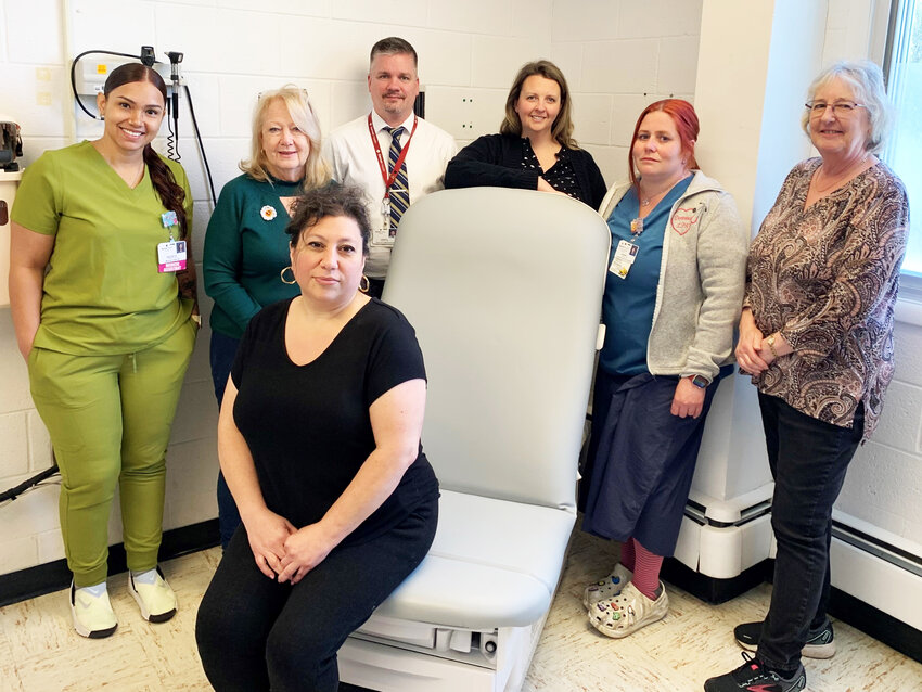 Garnet Health Doctors’ staff and Grover M. Hermann Auxiliary officers showcase the new power lift examination table. Pictured is Gina Napolitano, receptionist, seated. Standing from left is Destiny Arroyo, Medical Asst.; Peggy Richardson, Aux. President; Jason King, Practice Manager; Christina Wood, FNP; Deanna Calabrese, LPN; and Tess McBeath, Aux. Vice President.
