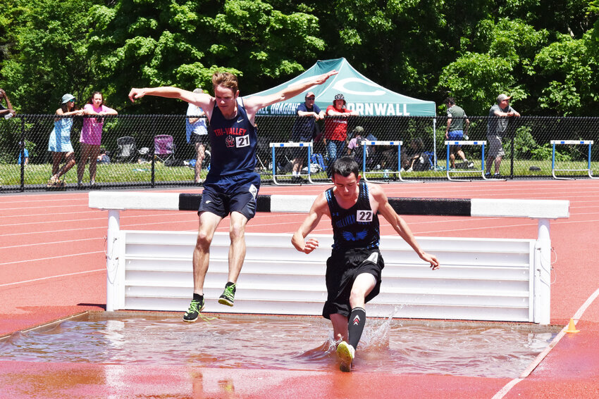 Tri-Valley’s Craig Costa and Sullivan West’s Landon Volpe leap into the water pit during the 3000m Steeplechase.