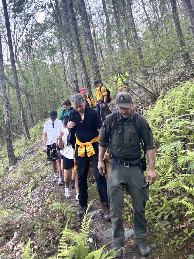 The group of hikers was led out of the state forest by the forest ranger.