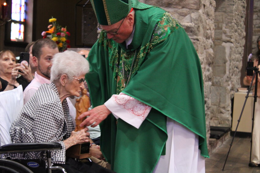 103-year-old Zita Speer was presented with a statue of St. Peter by Cardinal Timothy Dolan in honor of her late husband Harold Speer.