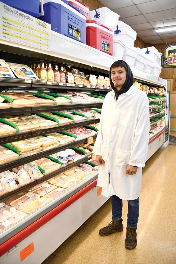 Peck&rsquo;s Markets meat wrapper Ryan Fredo checks on the meat case at the Callicoon Peck&rsquo;s yesterday morning.