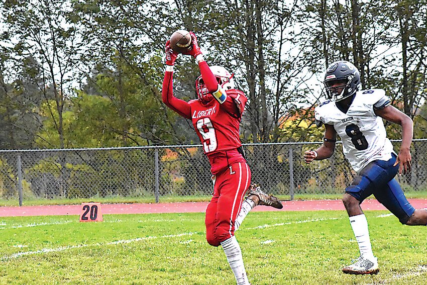 Jameel McCline pulls in a pass in the first quarter to set Liberty up for a touchdown during a game against Beacon last October.