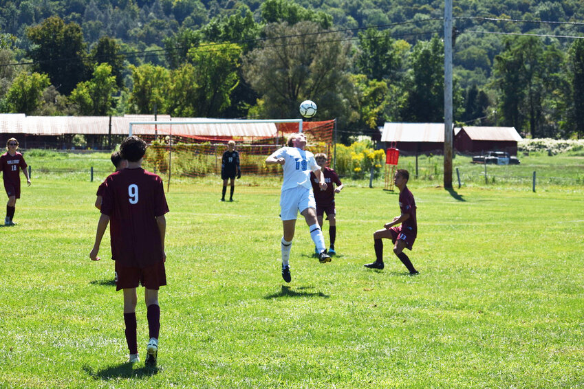 SW Boys’ #19 jumps up for a header.