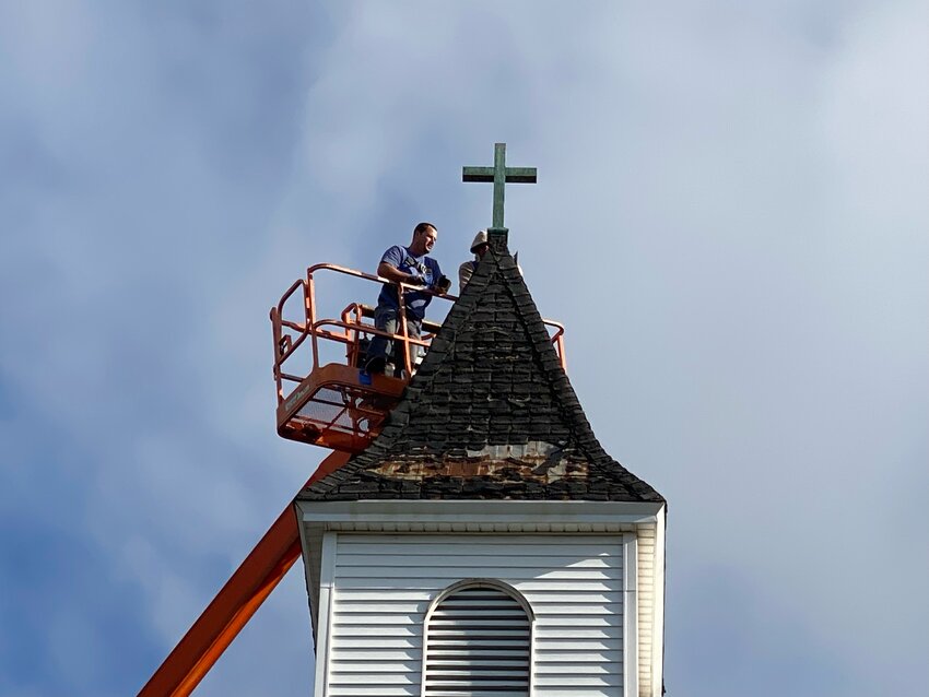 Tools were used to safely remove the cross from its perch.