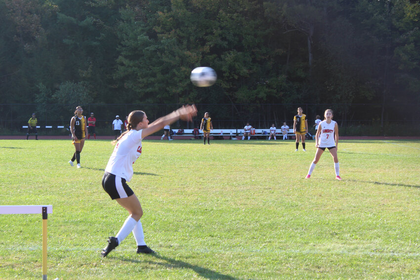 Sandra Hanofee of Liberty throws the ball in as teammate Audrey Krum awaits the play.