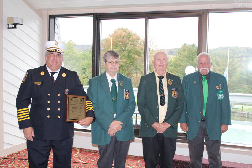 Sullivan County Fire Coordinator John Hauschild, left, was honored as the SCVFA Fire Service Lifetime Achievement Award. Joining him, fromthe left, are past winners of the award, Don Sherwood, Nelson Durland and the Honorable Terrence Mullen.