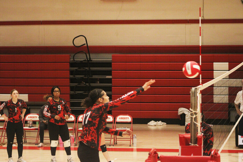 Julissa Velez takes a swing during pre-game warmups for the RedHawks prior to their match against O’Neill.