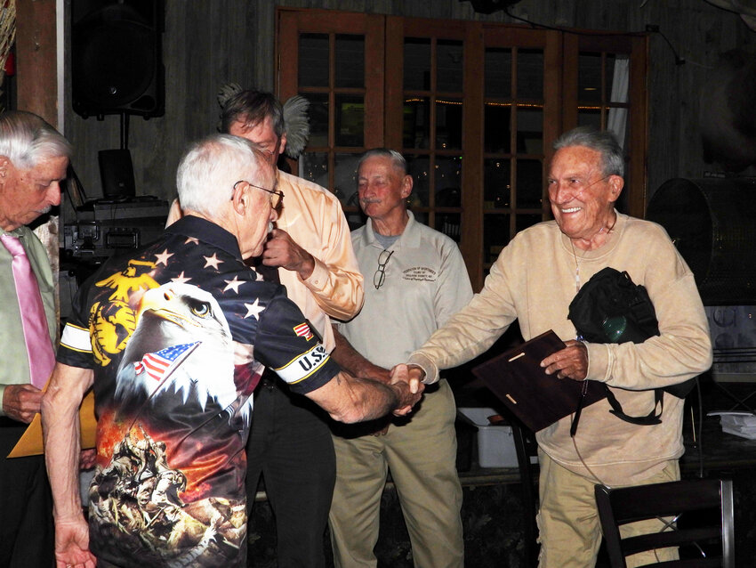 Duo winners of Sportsman of the Year, Ron Krom, left, and Al Spence, congratulate each other with a handshake and a smile.