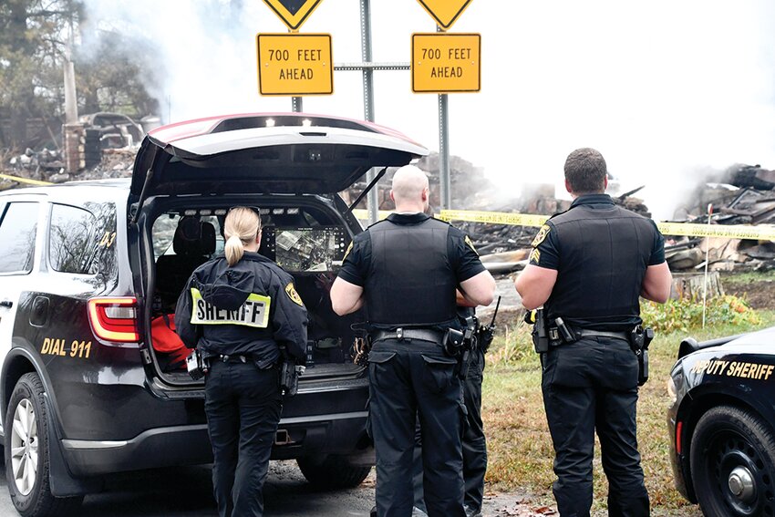 Deputies from the Sullivan County Sheriff’s office view a computer monitor as their drone flies over the burned home.