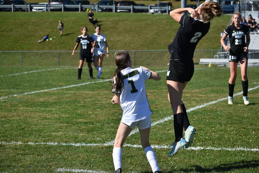 McKala Chevalier of Sullivan West jumps for a header while Eldred’s Ariana Fredricks defends.