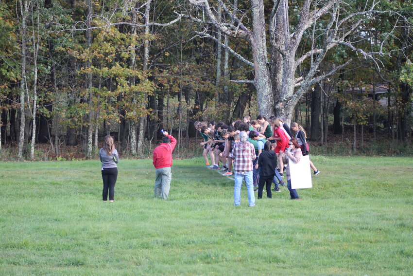 Runners line up at the start line for the Varsity Cross Country meet at Walnut Mountain in Liberty.