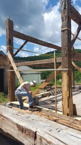 Zeke Boyle of Beechwoods Barns in Callicoon working on the 1880s barn at the 1930s Catskill Farm