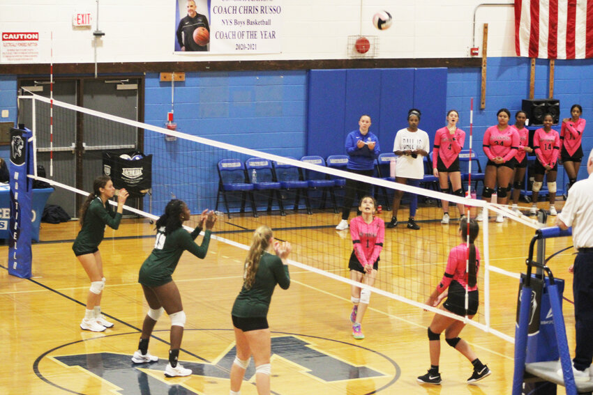 The Cornwall Dragons set up for a block and the net against the Monticello Panthers.