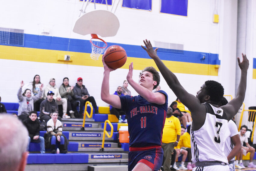 Tri-Valley&rsquo;s Josh Fanslau finger rolls a layup through multiple defenders.