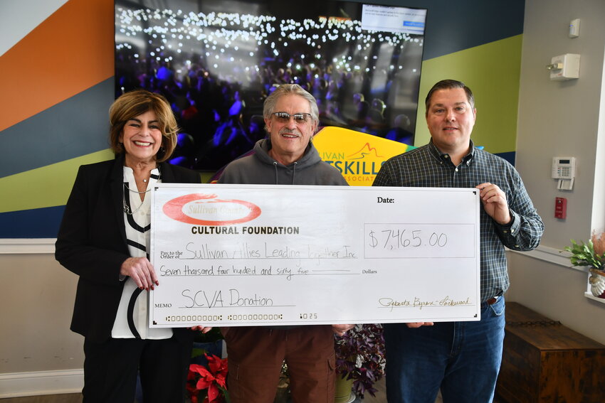 At right, The Sullivan Catskills Visitors Assn. presented this &lsquo;Big Check&rsquo; to SALT (Sullivan Agencies Leading Together) last Friday. SCVA President and CEO Roberta Byron-Lockwood and SCVA Board Chair Eric Frances, right, present the check to SALT Board Chair Martin Colavito.