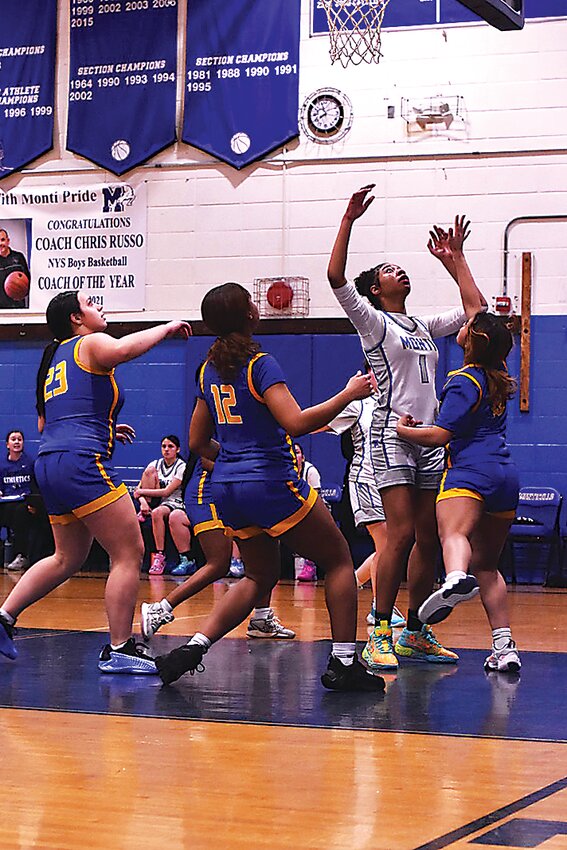 Melissa Negron of Monticello reaches for an offensive rebound.