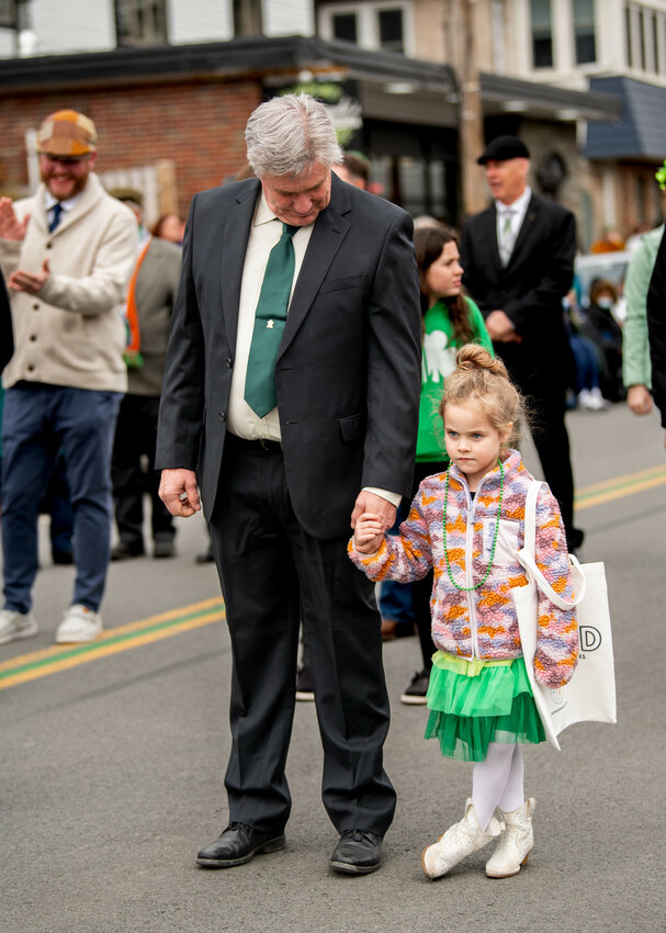 A very serious Sadie DeGori holds tight to grandfather Craig Boyd&rsquo;s hand while the two march with the Ancient Order of Hibernians Sullivan Brothers, hosts of the annual event.