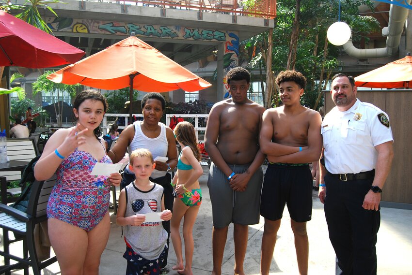 Fun was flowing like water down a slide on Friday afternoon at the Kartrite Water Park. From left: Bivbiana Kelly,  Joseph Thompson, Village Mayor Rochelle Massey, Savannah Thompson, Mehki Snowden, Ajayden Jacobs and Monticello Police Chief David Lindsay.