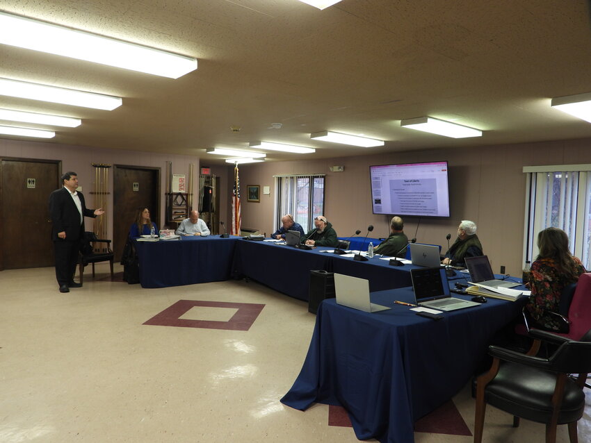 Andrew J. Arias of Cooper Arias LLP, left, presented the audit findings to the Liberty Town Board Monday night. He noted the town&rsquo;s reserve funds have continued an upward trend.