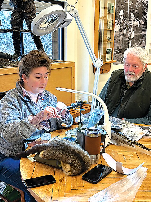 In the Catskill Fly Fishing Center&rsquo;s Museum on Saturday afternoon, Christina Muller, guest fly-tyer, explains to Ed Walsh how she ties her special &ldquo;guide&rdquo; flies using natural feathers and fur, along with some special &ldquo;sparkle&rdquo; mixed in.
