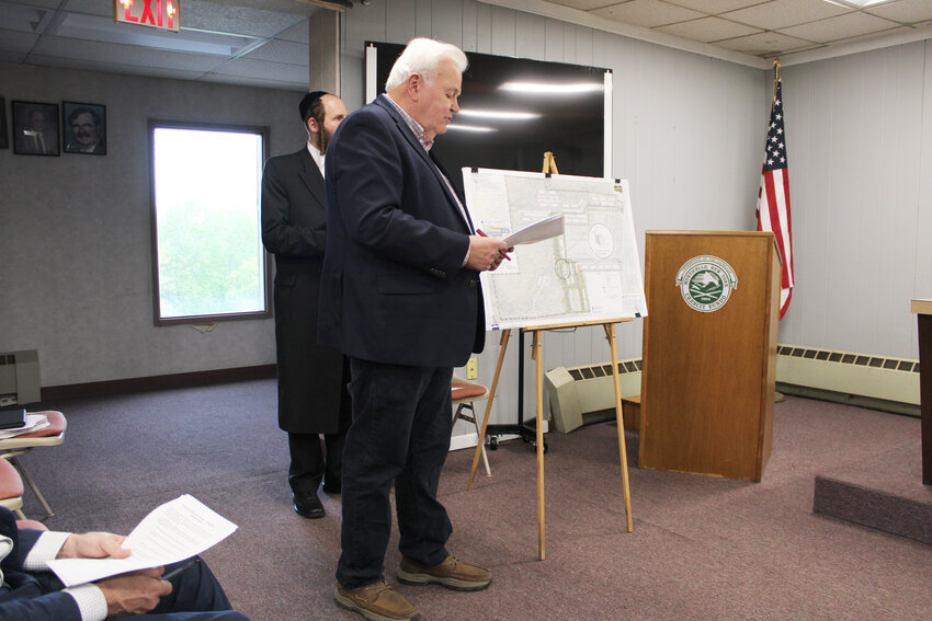 Tom Shepstone explains the details of the PUD that would come from Proposed Local Law #2 of 2025. Behind him, Joel Kohn listens on.