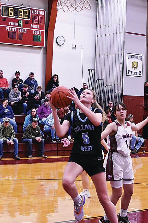 Six-foot sophomore Ella Herbert controlling the play down low on a fast break for the Sullivan West Bulldogs.