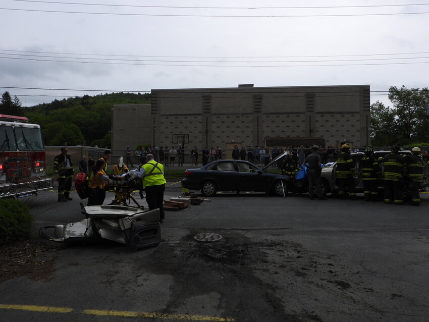 With just one day to go before their Prom Night, Roscoe Central High School students watch on as Rockland emergency personnel reminded of the need for safety behind the wheel with a reenactment the scene of a car accident behind the school Friday morning.
