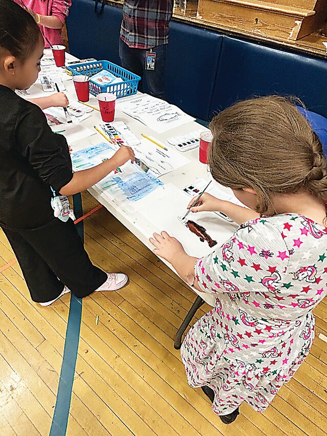 Children learned how to draw and paint trout at the art table.