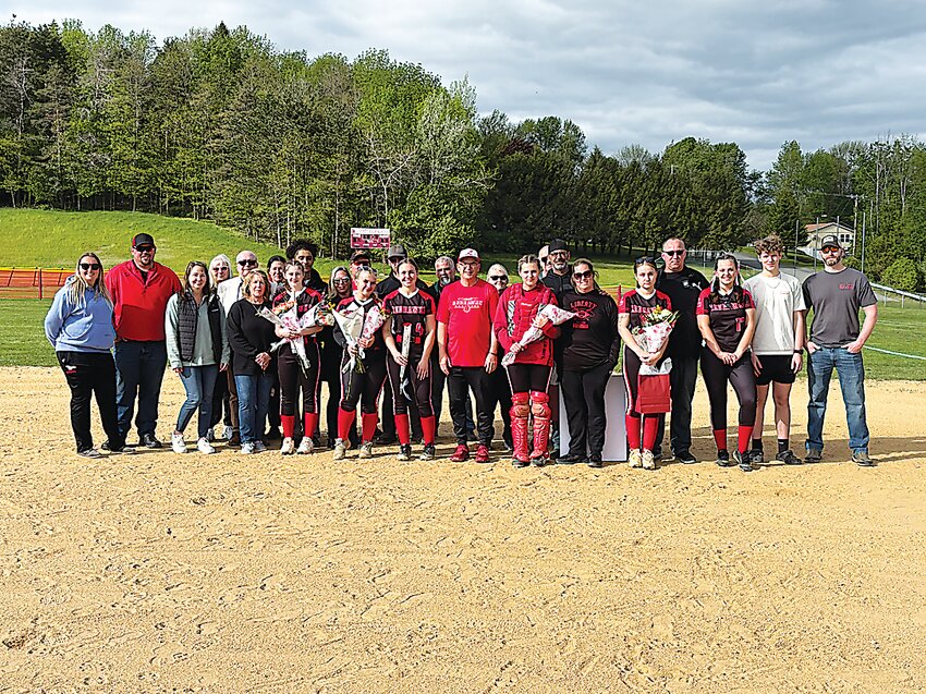Liberty Softball seniors surrounded by family, friends, and coaches inside the diamond on Senior Night earlier this week.