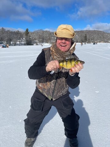 My dad having fun on an ice fishing adventure.