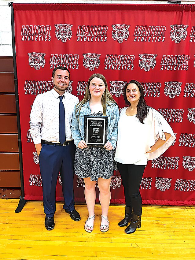 Left to right: Coach Nick Wyss, Clara LeRoy, and Coach Jan LeMyre.