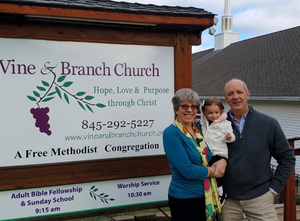 Vine & Branch Free Methodist Church in Liberty is linking with hundreds of new people via its on-line presence, say pastors Robin and Ed Sostak, here with granddaughter Lily.