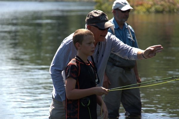 Mentors guide the children every step of the way when they enter the river to fish, many for the first time.