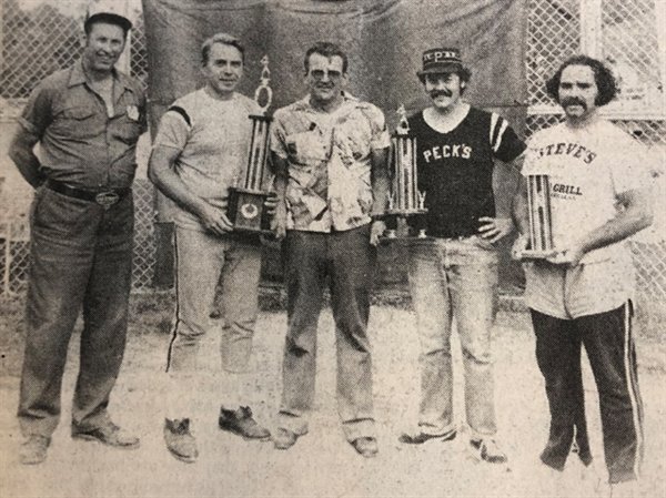 Team managers and sponsors accepted their hard earned trophies after the championship game of the Third Annual Pete's Pub Tournament. From the left are: Doug Heinle, sponsor of Heinle's; manager Stan Rembish of Heinle's, first place; Howie Murns, who handed out the trophies for Pete's Pub; Jim Nichols, manager of Peck's, second place; and Niel Trautschold, of Steve's Bar, third place.