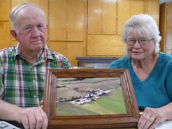 Bob and Linda Kays proudly share an aerial photo of their farm on Long Road in Callicoon. Linda Kays is spearheading a search for a milk processor who will keep the farms in business.