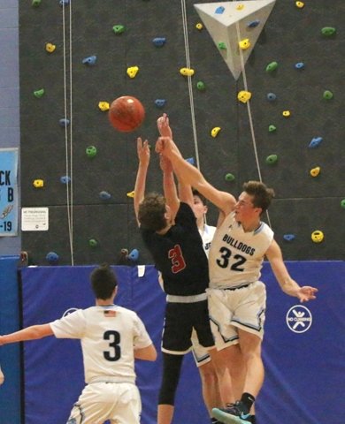 Sullivan West's Ryan Mace goes aloft to deflect a shot by Andrew Cox. He fouled Cox in the act but T-V's inability to convert needed free throws contributed to their loss.