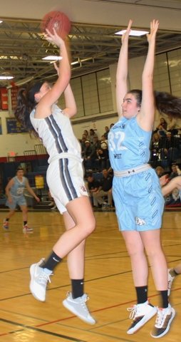 Tri-Valley junior center Juliana Kessler (15) shoots a two-point attempt over Sullivan West forward Taylor Hall (32) in the Bears' 57-45 win over arch rival Sullivan West on Monday night.