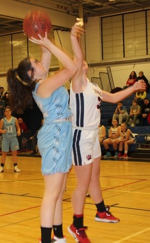 Sullivan West's forward Taylor Hall shoots a two-point attempt while guarded by T-V's Victoria Swett.