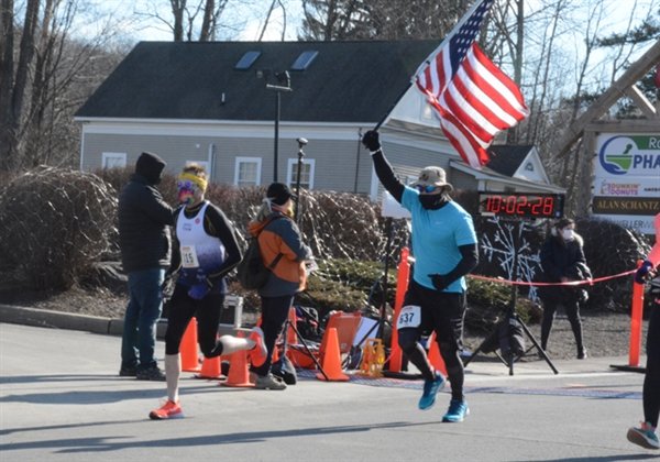 Luis Soltero, of New Windsor, ran with the American Flag.