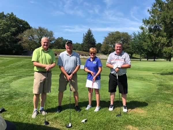 The family foursome of Mark McLoughlin, Eddie McLoughlin, Maggie Smith, and Bryan McLoughlin enjoyed a beautiful day at West Hills Country Club for Catholic Charities' 14th annual Golf for Charity Outing.